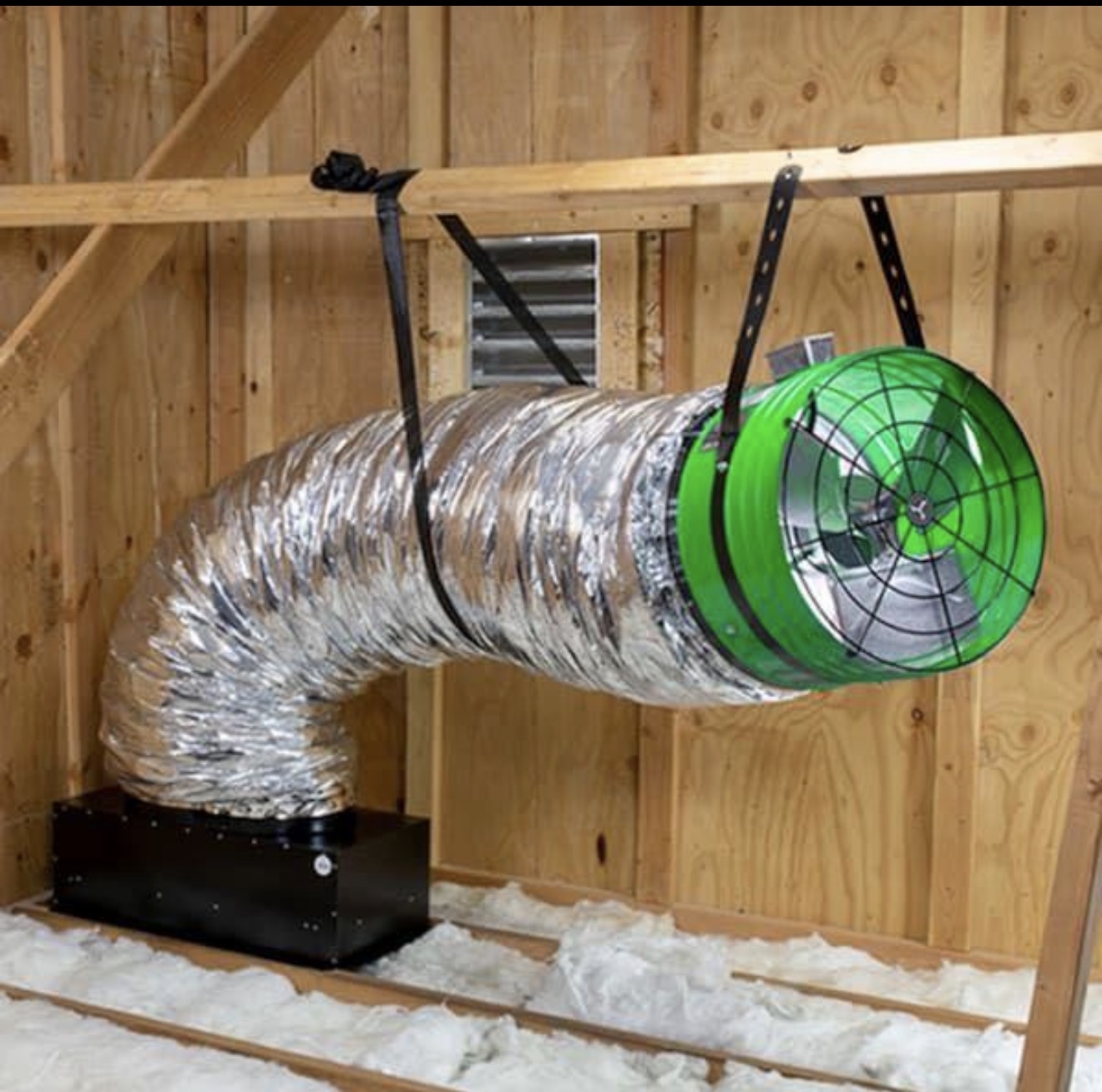 Ducted whole-house fan suspended in an attic